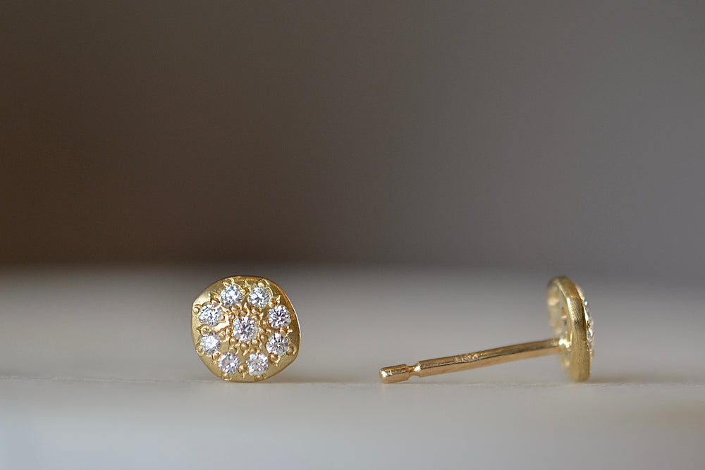 Charm stud earrings by Adel Chefridi in 18k yellow gold and adorned with white diamonds on classic post closure. 