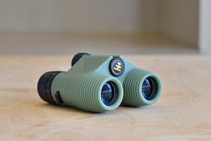 Side view of Standard Issue Binoculars 10x25 in Sage Green by Nocs. 
