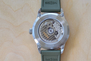 Back of Weiss Watch 38mm Automatic Field Watch with Black Dial and date, shown with olive rubber strap , made with American parts. 