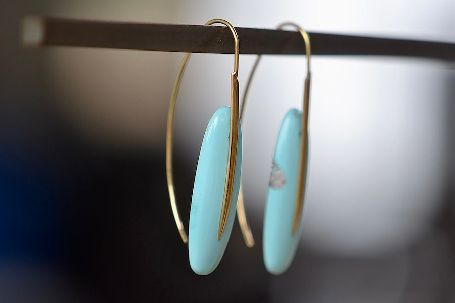 Side view of Feather Earrings in Turquoise with natural inclusions and 18k gold hooks by Rachel Atherley.