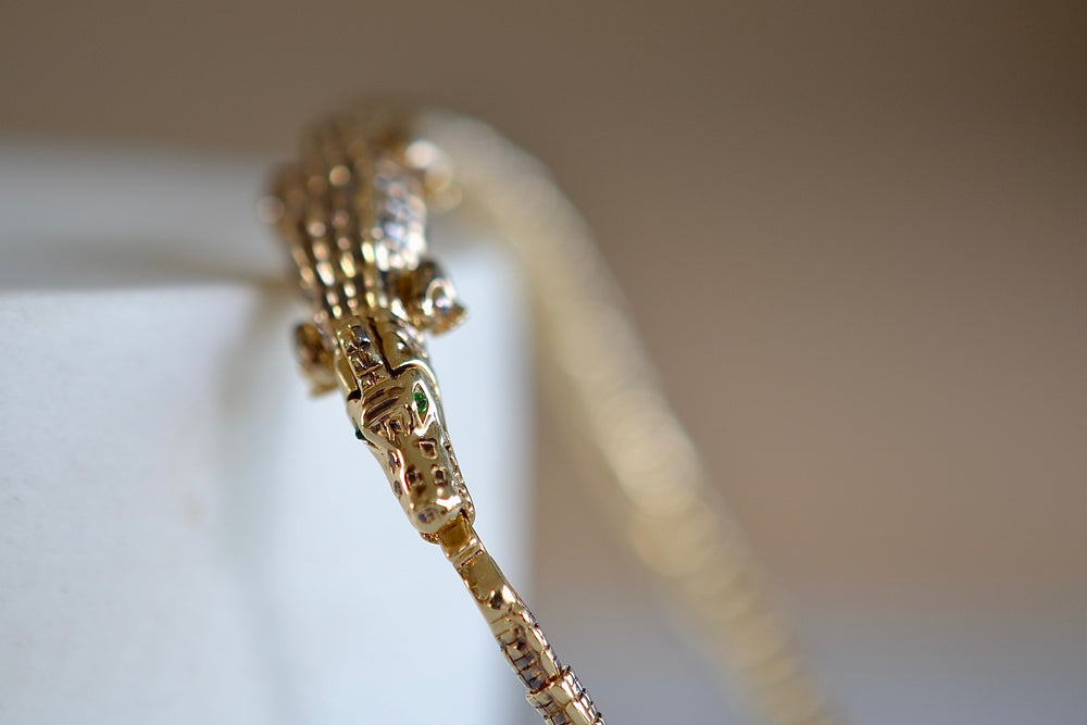 Close up of the snap lock on the Alligator Wrap Thin Bracelet by Bibi Van Der Velden with tsavorite eyes.