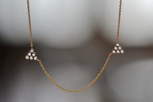 Close up of Duo Triangle Necklace by Yannis Sergakis.