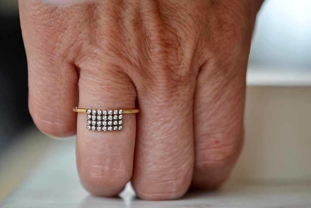 Wearing the Charnières Rectangular Ring designed by Yannis Sergakis. 