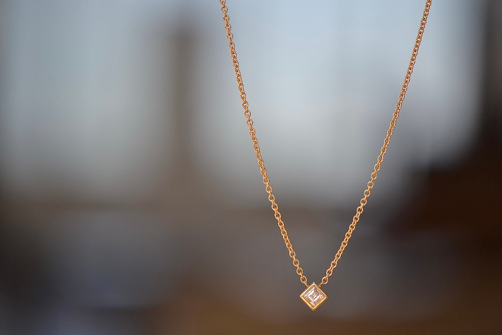 Carre Cut Diamond Bezel Solitaire Necklace by Lizzie Mandler is a A beautiful carre cut and bezel set diamond pendant on a classic adjustable cable chain in 18k yellow gold. 