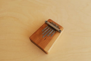 Kalimba in small (5) five fingers is a traditional instrument of the Shona people of Zimbabwe. These high quality Kalimbas are made of solid cherrywood by a small family firm in Walsrode Germany.