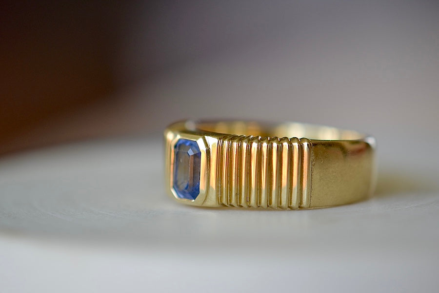 Retrouvai Pleated Blue Sapphire Solitaire with tapered band in 14k yellow gold, Emerald cut sky blue sapphire signet or wedding band, One of a kind - size 7.25 (minor sizing adjustments possible).