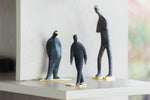 Carl Aubock landing page showing three "man" sculptures in brass.