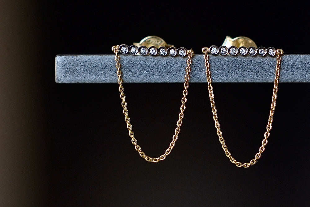 Close up view of Yannis Sergakis' Bar and chain earrings.