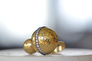 
            
                Load image into Gallery viewer, Duo Ball Ring by Arman Sakisyan is a double sphere ring with one larger and one smaller hollow and engraved ball on an open form and slightly tapered band. The larger sphere has a band of oxidized silver filled with 32 diamonds and filigree. Handmade in California.
            
        
