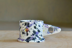 EXP standard splatter mug in purple and black by Peter Shire and Echo Park Pottery. It's great to hold in your hand.