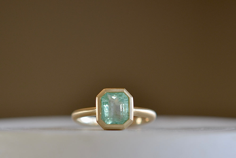 
            
                Load image into Gallery viewer, Simple Emerald Rectangular ring by Elizabeth Street made with a pale Columbian emerald.
            
        
