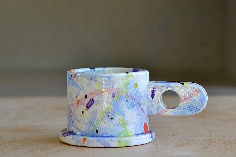 EXP standard splatter mug in blue with an acid green X by Peter Shire and Echo Park Pottery.