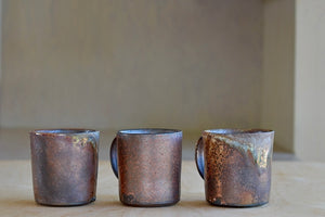 Selection of wood fired ceramic mugs by Lindsey Oesterritter. Wood ash in the kiln results in highly varying surfaces so each one unique,. As beautiful as they are functional. Sizes vary slightly, glazes considerably. These are part of our web selection and numbered 1, 2 and 3.