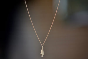 Triple Fringe Necklace designed by Carla Caruso is made out of three elongated fringe drops of graduated length have been hand shaped, hammered and hung from a ring that is connected to a chain in 14k yellow gold and satin finish.