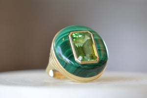 
            
                Load image into Gallery viewer, The Large Lollipop Ring in malachite and Green tourmaline by Retrouvai is a one of a kind signet ring featuring a chunky and rounded stone face with a translucent center stone set on a tiered edge and tapered band. This one is malachite with an emerald cut green tourmaline in the center. 
            
        