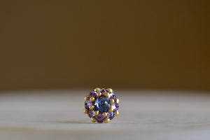 
            
                Load image into Gallery viewer, Larkspur stud earring by Polly Wales is a  single earring is a smaller floral cluster made out of a half sphere in gold with a cabochon and encrusted inverted brilliant sapphires. We have one in blue and lavender.
            
        