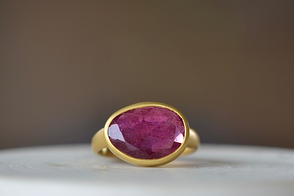 The Pink Tourmaline Large  Greek Ring by Pippa Small Jewellery is an organically shaped, and hand cut, deep pink, faceted and translucent pink tourmaline set in 18k yellow gold. Size 7 in stock.