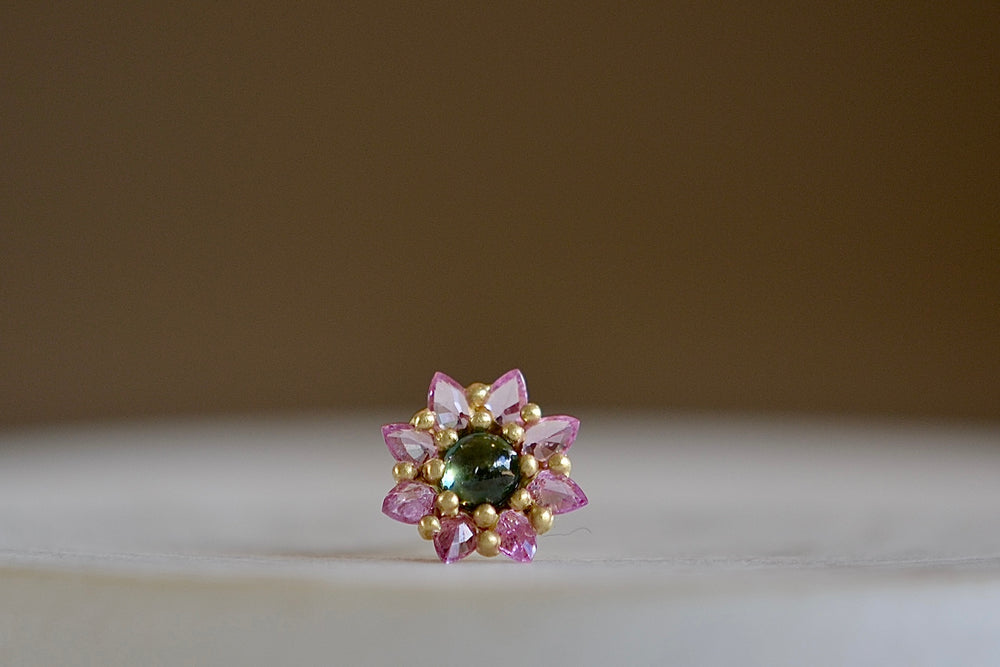
            
                Load image into Gallery viewer, The Daisy stud by Polly Wales is a floral cluster made out of a half sphere in gold with a cabochon and encrusted inverted brilliant sapphires. We have one in green and pink.
            
        