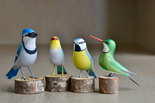 Selection of wooden and hand carved birds from Brazil, showing Blue Jay, Red Beak, Blue Tit and White Throated Hummingbird.