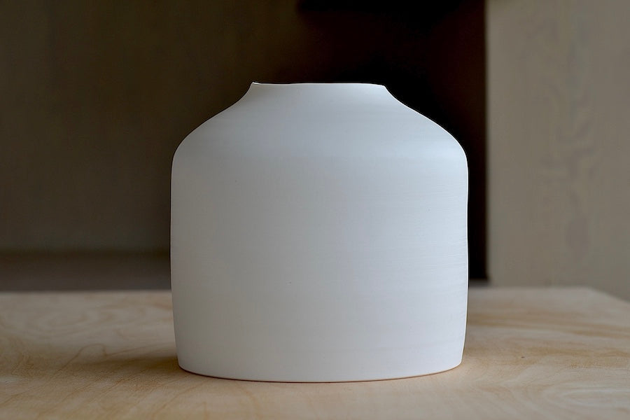 
            
                Load image into Gallery viewer, Lilith Rockett Urn Vase is wheel thrown porcelain with gloss glaze on the interior and an unglazed exterior.
            
        