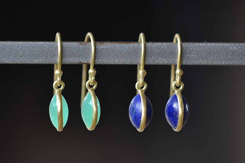 Small Moon Earrings by Tej Kothari are round and smooth cabachon stones in chrysoprase or lapis that are set in gold and hang on earwire.