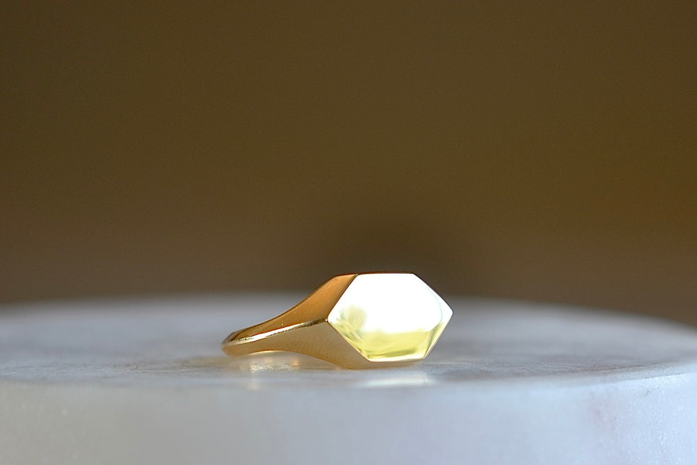 Hexagonal Reflection Signet ring by Makiko Wakita is an 18k high polish signet ring with crisp edges and a hexagonal face. The band has s beautiful knife edge. This signet ring is unisex. A Handmade in Los Angeles. 