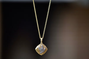 The Bird Sliding Locket by Arman Sarkisyan is a A rhombus shaped sliding locket in 22k gold with a bird motif in oxidized silver and accent diamonds hangs on a beautiful gold chain.