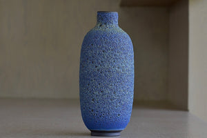 Heather Rosenman Tall Blue with Yellow Volcanic Vase is a one of a kind and handthrown ceramic vase.