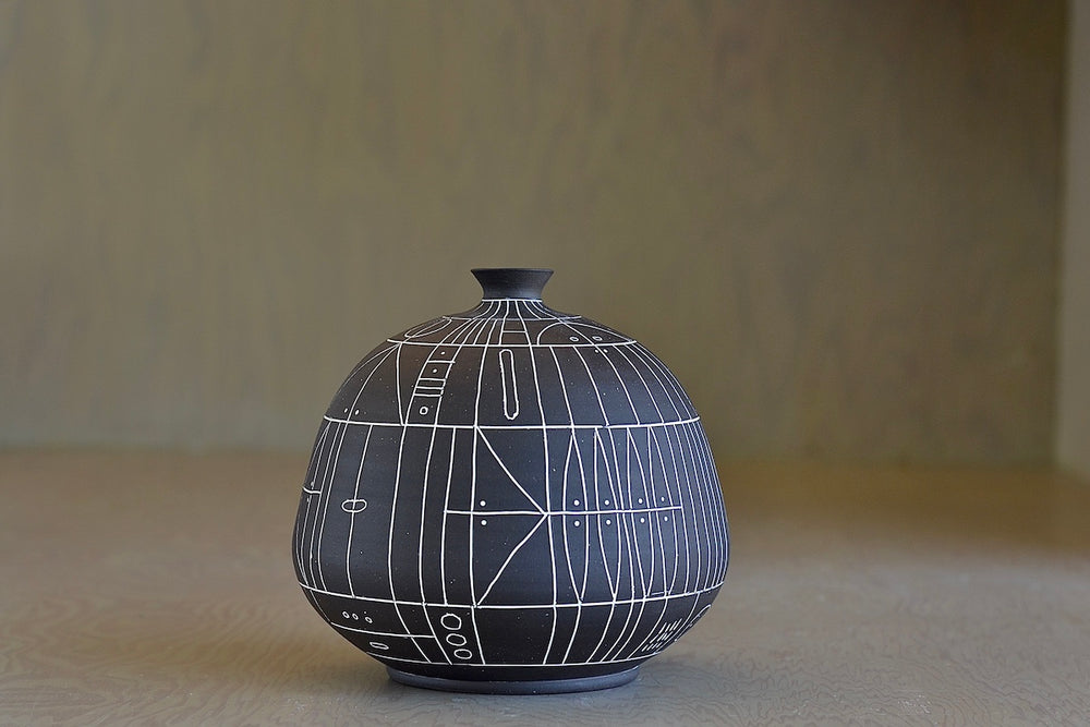 The HR 400 'Scribe" vase is a ceramic  hand thrown stoneware vase with sgraffito patterns by Heather Rosenman. 