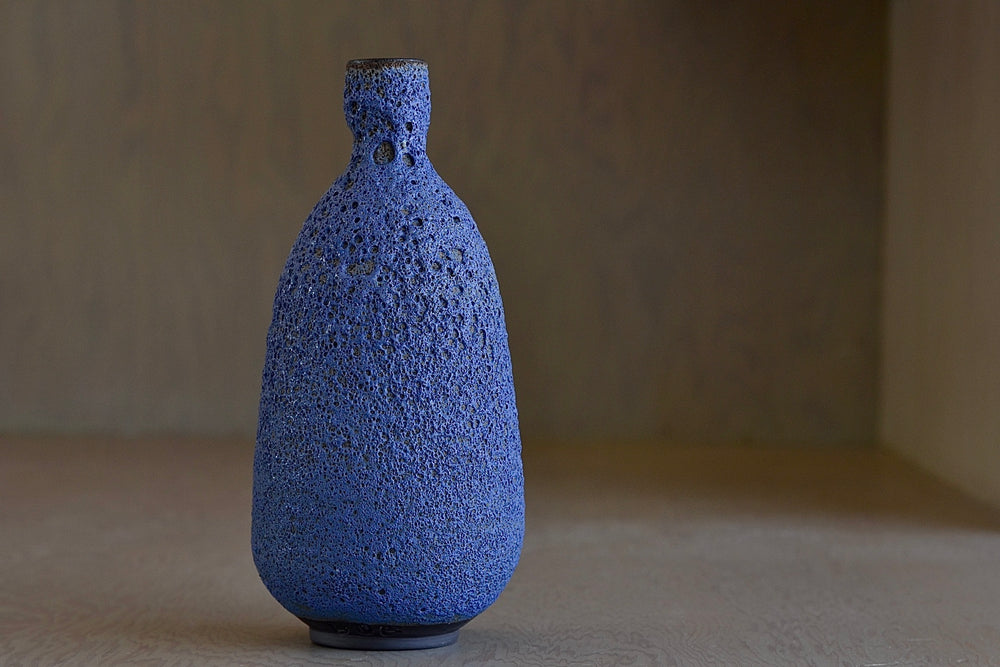 
            
                Load image into Gallery viewer, Tall Blue Bottle vase in volcanic glaze by Heather Rosenman.
            
        