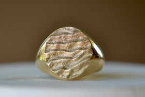 Close up of yellow gold Tidal round signet by Fraser Hamilton.