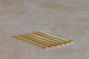 Alternate view of a set of six gold circle and gold plated cocktail picks made in Japan.