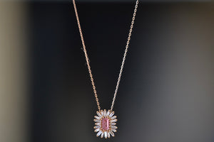 Pink Sapphire Necklace with Diamond Baguette Halo by Suzanne Kalan is a  one of a kind necklace with a center pink sapphire surrounded by a 20 white diamond baguette halo in a firework setting and on an 18k rose gold chain. 