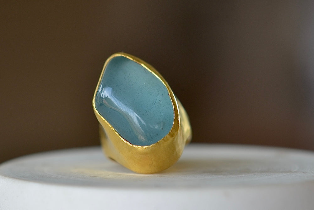 The Aquamarine Tibetan Ring designed by Pippa Small Jewellery is based on a ring that Pippa bought in Tibet many years ago this design features a hand picked and smooth tumbled aquamarine that is encased in 22k gold.