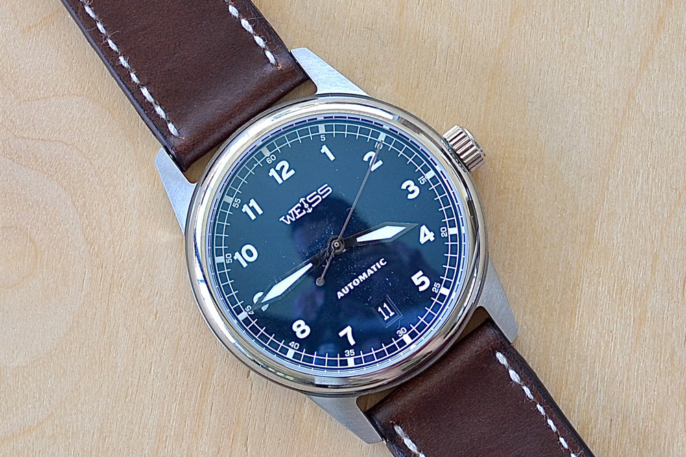 Weiss Watch 38mm Automatic Issue Field Watch with Navy Blue Dial and date, shown with dark brown Horween Leather strap. This watch is made with American parts, featuring Super Luminova hands and markers. 