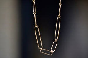 Short 14k gold paperclip chain with two short, one long flat clips in 15 inches by Kaylin Hertel.