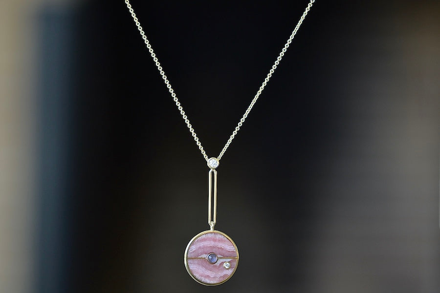 
            
                Load image into Gallery viewer,  The signature Compass Pendant with Rhodochrosite and Tanzanite by Retrouvai is a pendant necklace with stone inlay that is accented with a center gem stone and a white diamond. The compass hangs from an elongated paperclip link accented with a second white diamond on 24&amp;quot; 14k yellow gold chain.
            
        