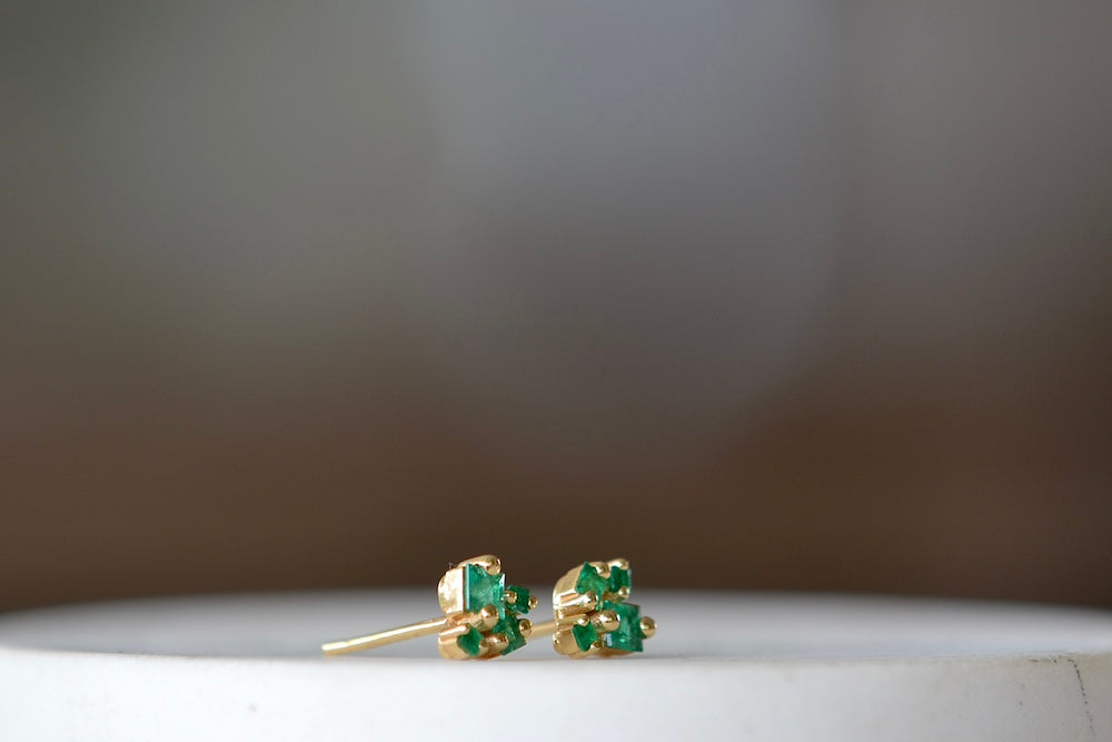 18K Princess Emerald Stud earrings by Suzanne Kalan are made out of four princess cut emeralds each in her fireworks setting with 18k yellow gold post closure. Sold as a pair.