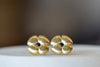 Large flower stud earring by Kaylin Hertel is a stud earring in the shape of a flower in 14k gold with a black diamond in the center and post closure. 