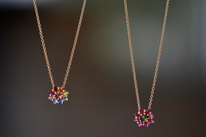 Daisy Necklace by Polly Wales in two color ways. A floral cluster made out of a center cabochon and a row of encrusted and inverted brilliant marquise sapphires in green and pink or pink and rainbow hangs on a beautiful 18k yellow chain. Recycled gold. Cast in Place. Cast not set. 