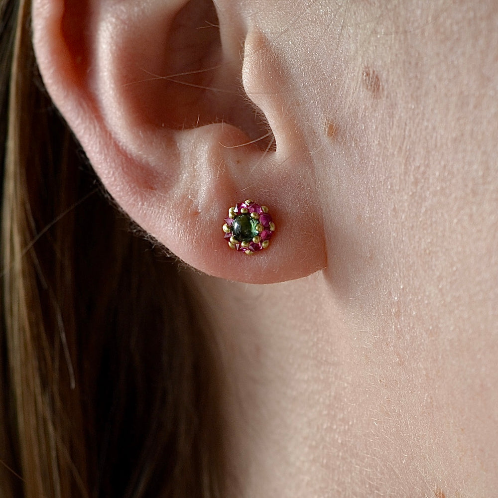 Wearing the Larkspur Stud earring by Polly Wales. Green and pink.