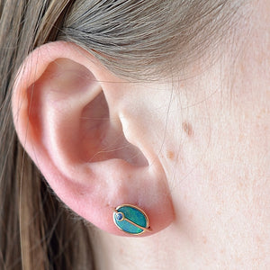 Wearing the Small Planet Stud Earrings by Bibi Van Der Velden. 