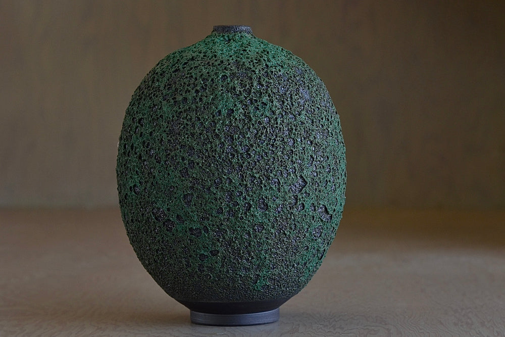 
            
                Load image into Gallery viewer, Alternate view of Heather Rosenman Tall Oval and Deep forest green ceramic  Vase in volcanic glaze.
            
        