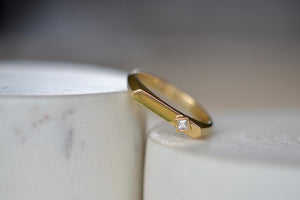 Leaning Offset Carré Flat Top Ring by Lizzie Mandler is a wide flat top ring, signet or pinkie ring with signature knife edge shank band and one offset and bezel set carré cut diamond. This ring is unisex and handmade in Los Angeles.