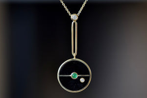 
            
                Load image into Gallery viewer, Close up of the signature Compass Pendant with Black Onyx and emerald by Retrouvai is a pendant necklace with stone inlay that is accented with a center gem stone and a white diamond. 
            
        