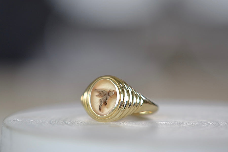
            
                Load image into Gallery viewer, Angled view of A Retrouvai Baby Fantasy Signet in Flying Pig is a 14k polished and tiered yellow gold pinky ring with an engraving that reads &amp;#39;anything is possible&amp;#39;. Unisex jewelry.
            
        