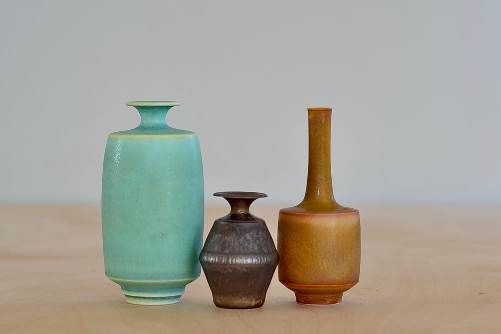Miniature Hand Thrown Ceramic Vase Trio in Green, Ochre and Brown by Yuta Segawa on white background.