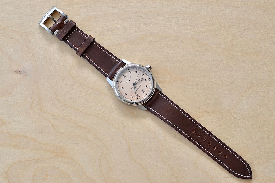 
            
                Load image into Gallery viewer, Full view of Weiss Watch 38mm Automatic Issue Field Watch with Latte Beige Dial and date, shown with dark brown Horween Leather strap. This watch is made with American parts, featuring Super Luminova hands and markers. 
            
        