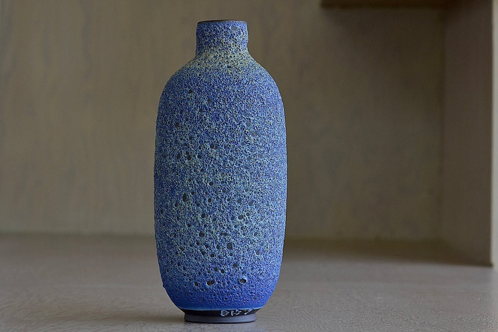 Alternate angle of Heather Rosenman Tall Blue with Yellow Volcanic Vase.