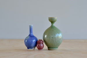 Miniature Hand Thrown Ceramic Vase Trio by Yuta Segawa in Purple, Green and Reddish Brown on white background.